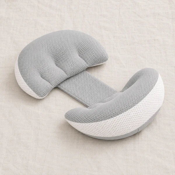 Compact two-lobe side pillow joined by a strap, laid on a light bed